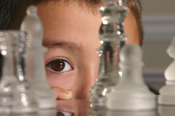 A young boy playing chess.