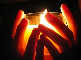 Holding a candle.