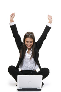 Woman on laptop getting good news.