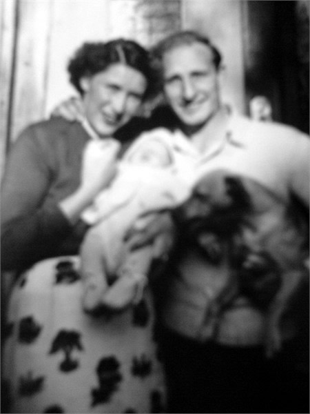 Gisela, Patrick, baby Raymond and their dog Jim.