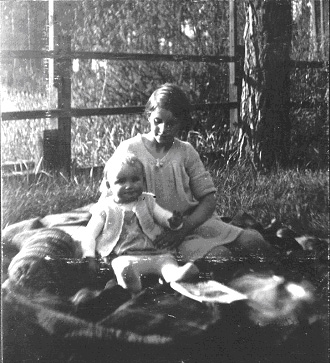 Dieter 9 months and Gisela 8 years old in the wood garden