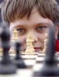 Image of boy concentrating on chess